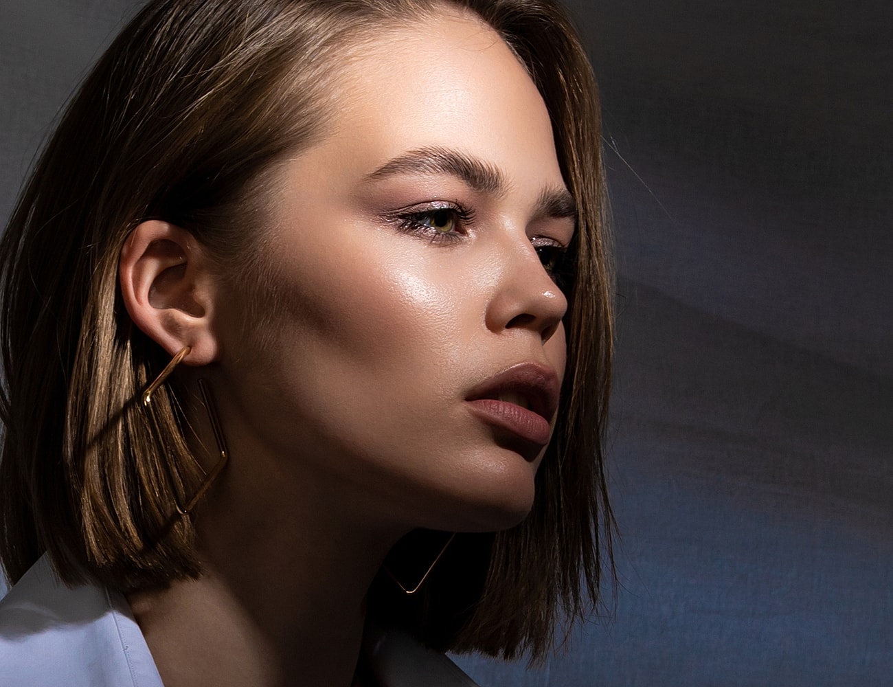 Profile of a woman with stylish earrings.