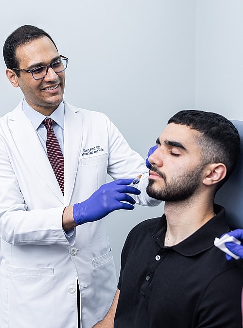 Doctor administering treatment to patient in clinic.