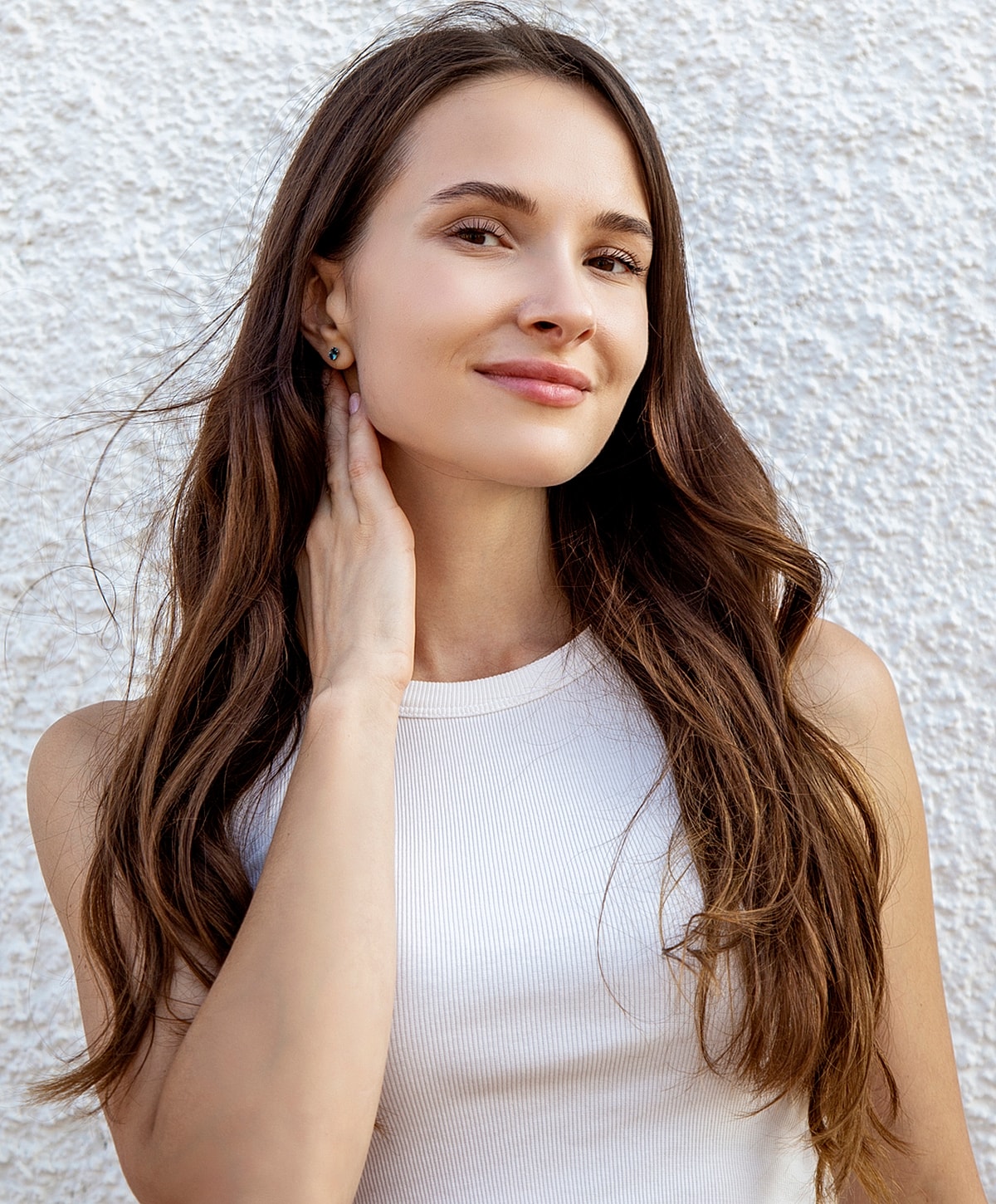 Woman with elegant hairstyle and white blouse.