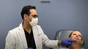 Doctor performing a cosmetic procedure on patient.