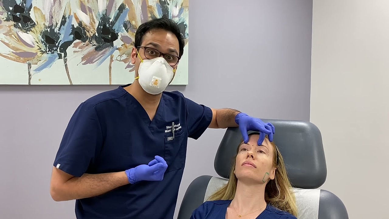 Doctor performing a cosmetic procedure on a patient.