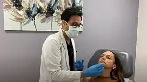 Doctor treating patient in a clinical setting.