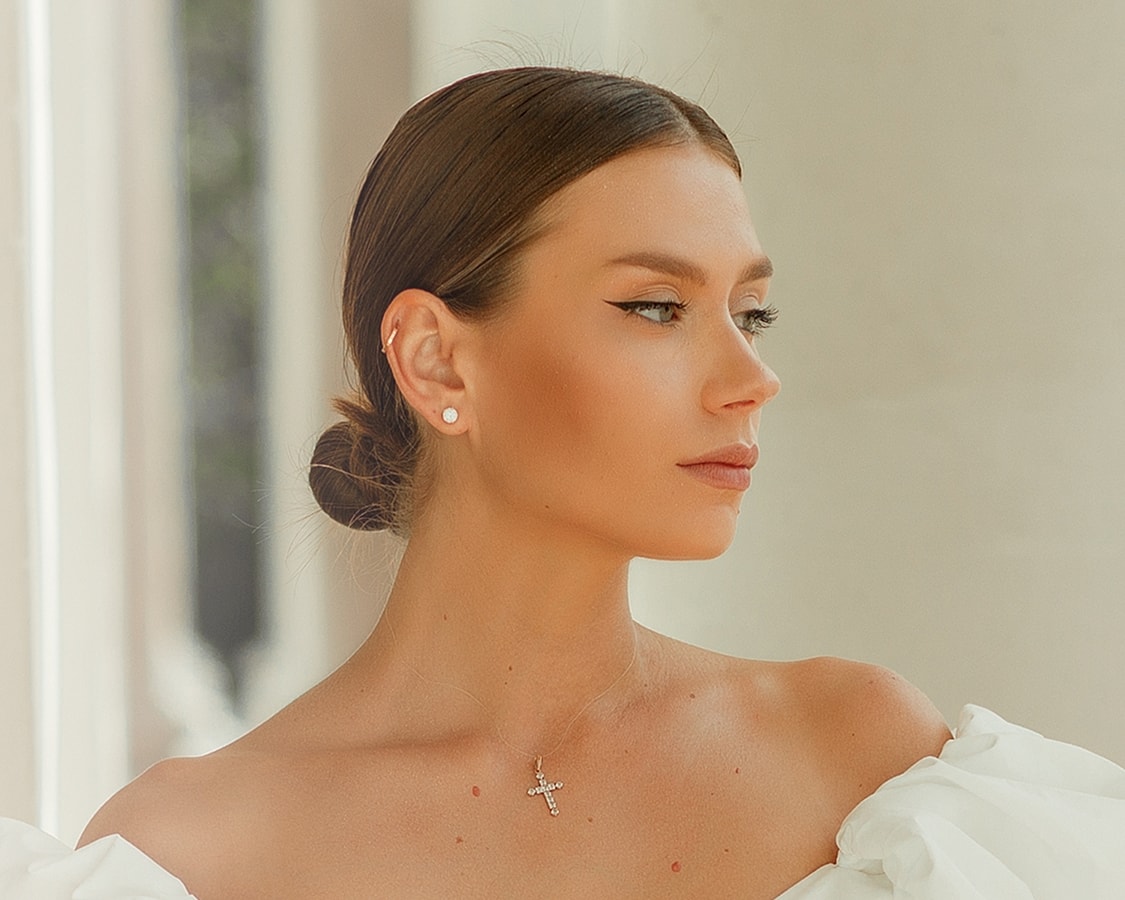Woman with elegant hairstyle and jewelry profile.