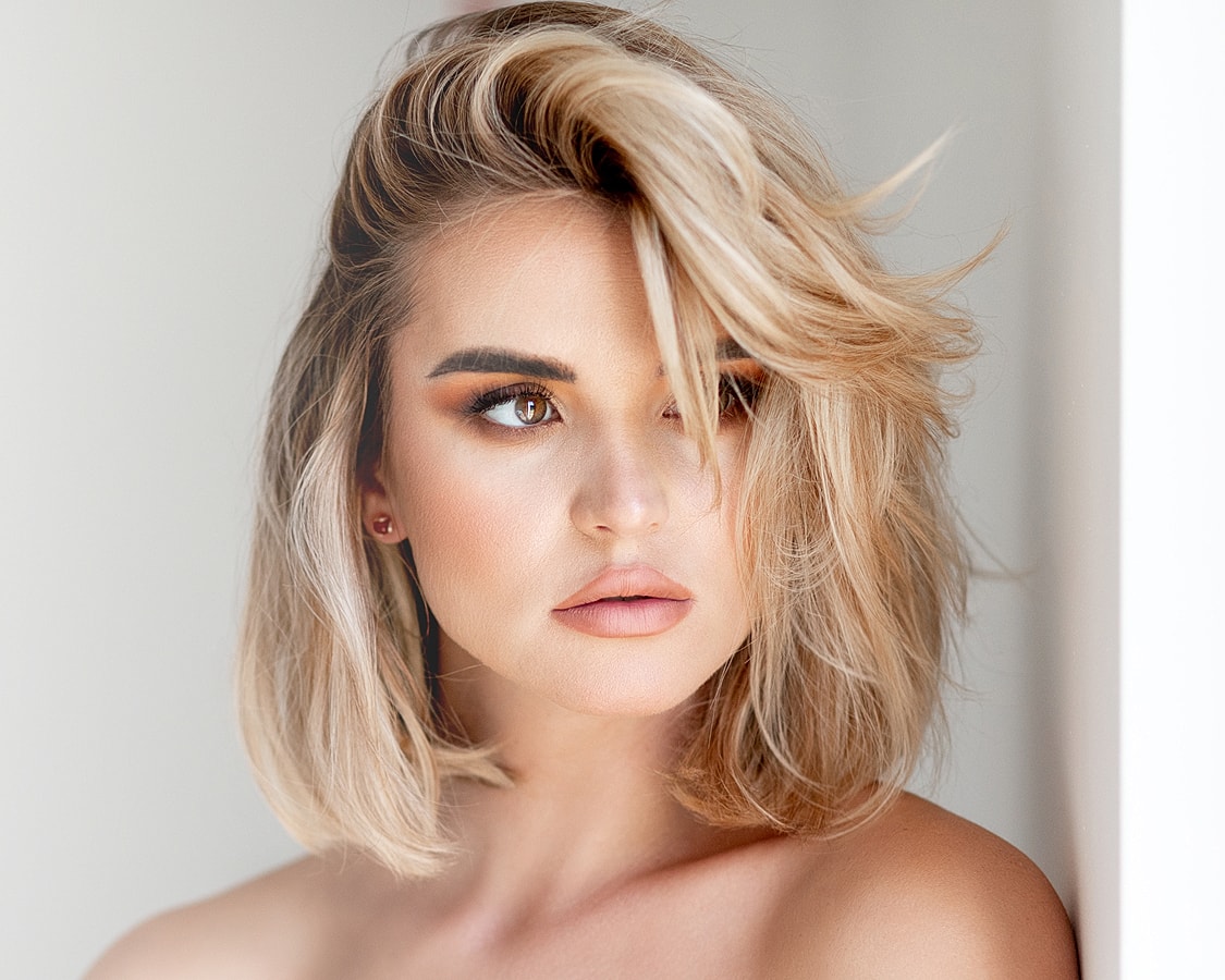 Woman with blonde hair and natural makeup.