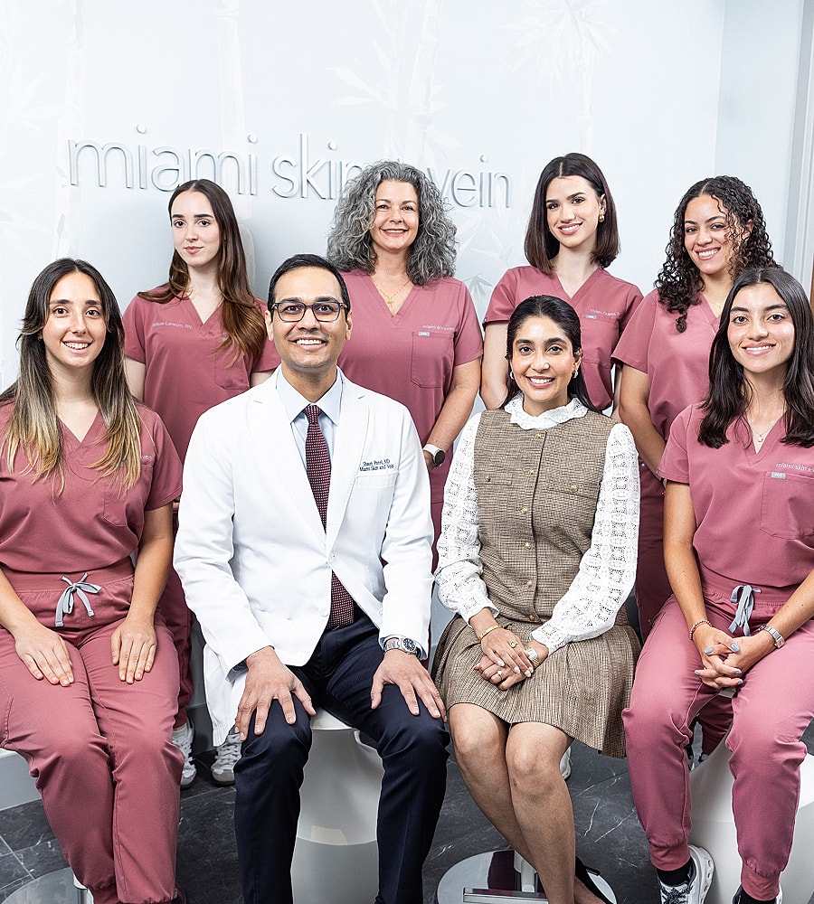 Medical team posing in clinic setting.