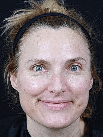 Smiling woman with natural makeup and headband.