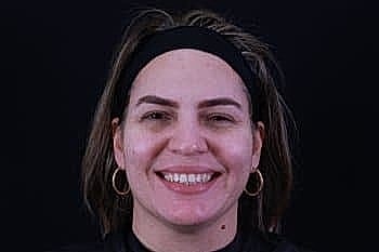 Smiling woman with medium-length hair and headband.