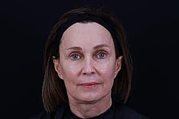 Woman with straight hair and neutral expression.