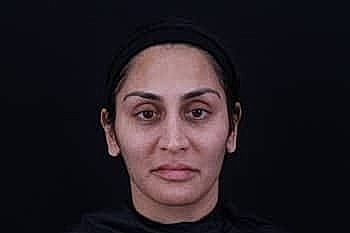 Portrait of a woman with neutral expression.