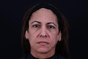 Portrait of a woman with a neutral expression.