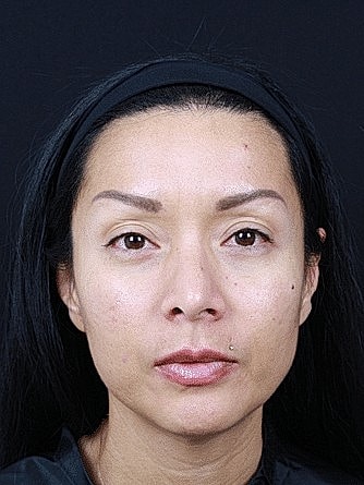 Woman with long dark hair and minimal makeup.
