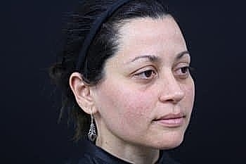 Profile of a woman against a dark background.