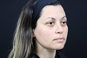 Woman with long hair against black background