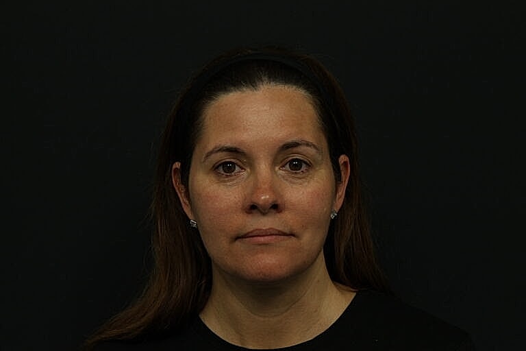 Portrait of a woman with neutral expression.