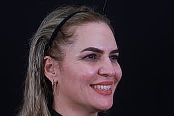 Smiling woman with long blonde hair.