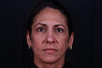 Portrait of a woman against a dark background.