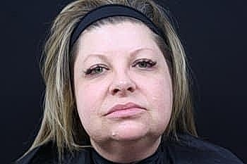 Woman with natural makeup and long hair.