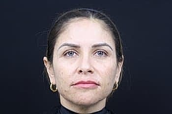 Portrait of a woman with long dark hair.