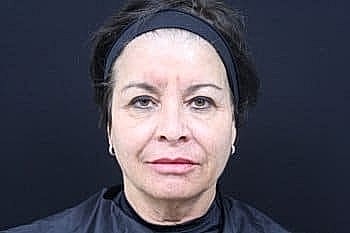 Mugshot of a woman with dark hair.