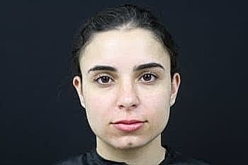 Portrait of a woman against a dark background.