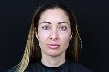 Person with long hair and neutral expression.