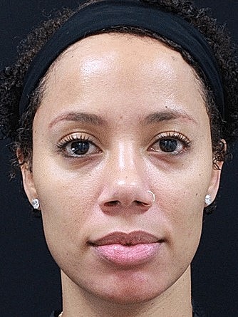 Portrait of a woman with curly hair.