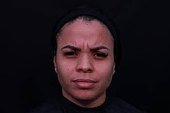 Portrait of a woman against a dark background.