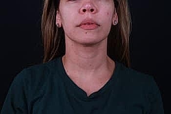 Person with long hair against dark background