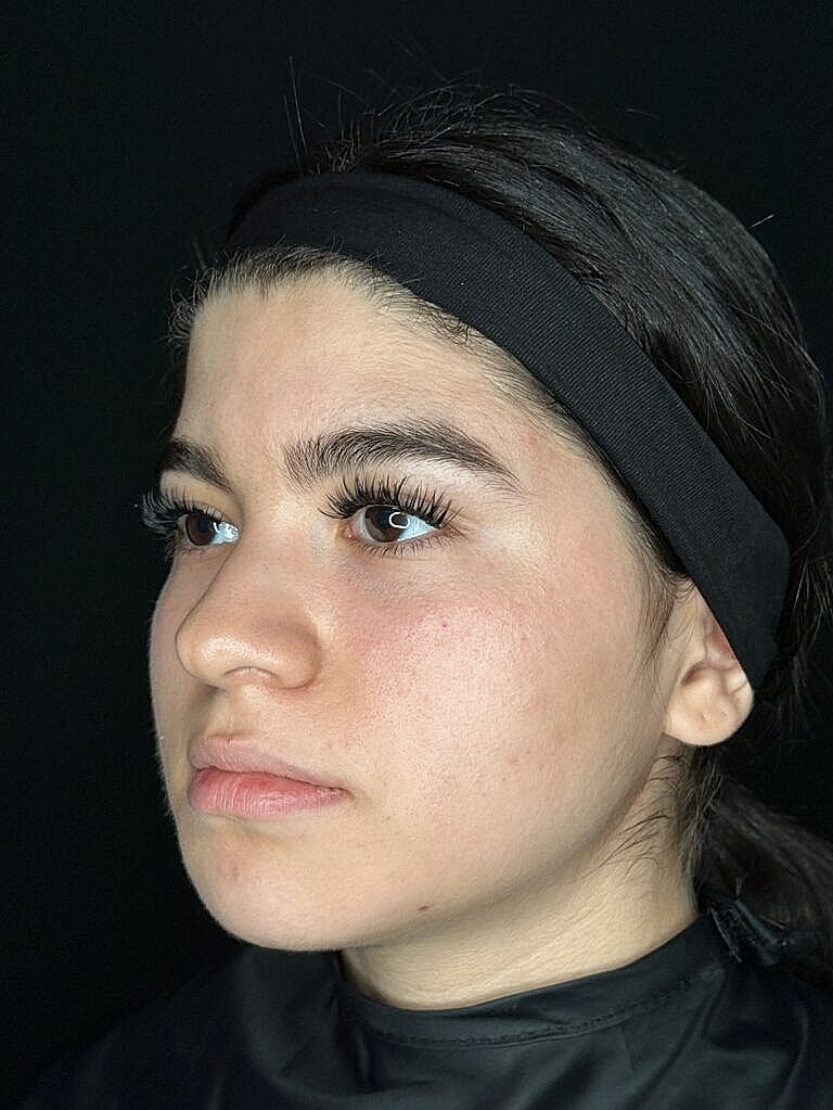 Profile of a young woman with makeup.