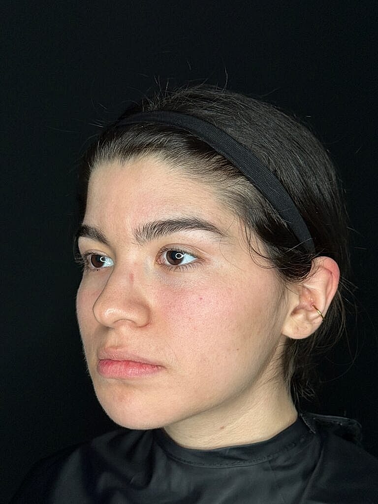 Profile of a young woman with natural makeup.