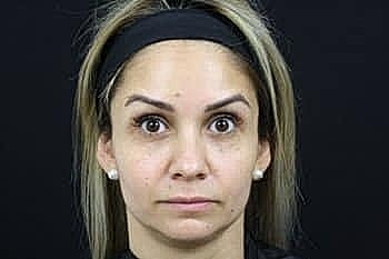 Portrait of a woman with neutral expression.