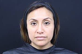 Portrait of a woman with neutral expression.