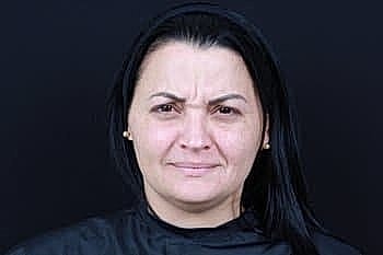 Person with straight black hair and serious expression.