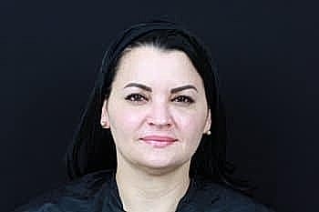 Woman with black hair on dark background