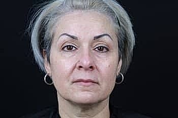 Portrait of a woman with short gray hair.