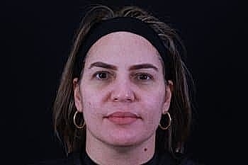 Portrait of a woman against a dark background.