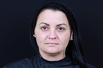 Woman with long black hair in dark setting
