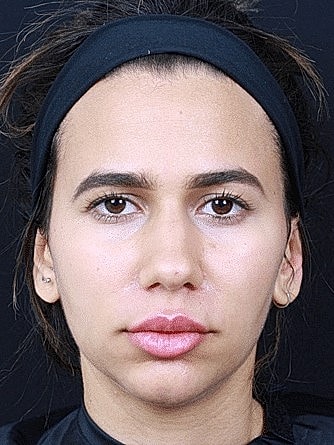 Close-up of a woman's face, neutral expression.