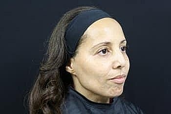 Woman with long hair against dark background