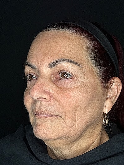 Woman with brown eyes and styled hair.