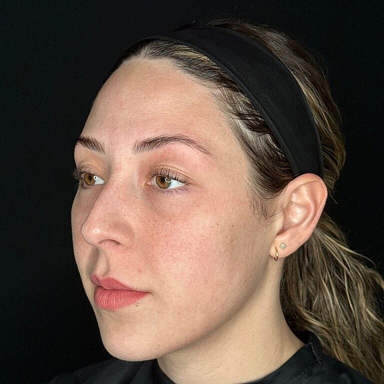 Profile of a woman against a black background.