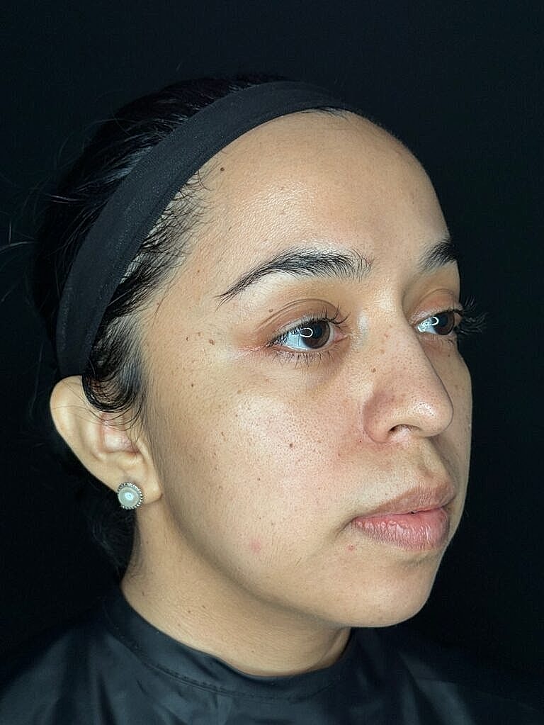 Woman with natural makeup and black background.