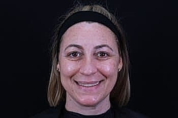 Smiling woman with medium-length hair and headband