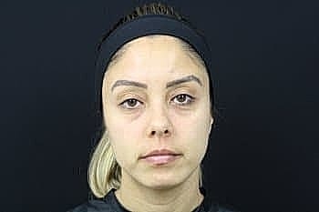 Woman with neutral expression and headband.