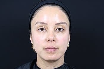 Woman with natural makeup against black background