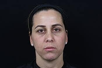 Portrait of a woman with neutral expression.