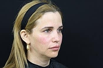 Woman with long hair and hoop earrings.