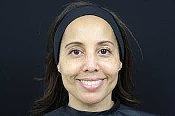 Woman smiling with a headband on.