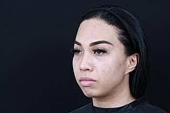 Portrait of a woman with dark hair.