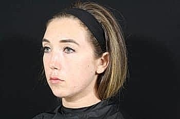 Woman with short hair and black headband.